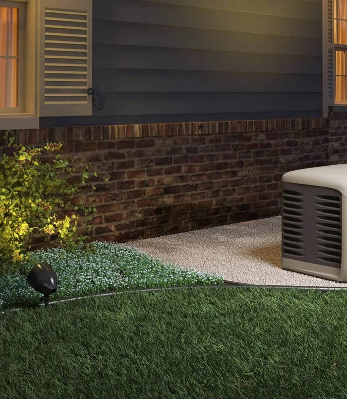 Home standby generator installed beside a South Florida house at dusk